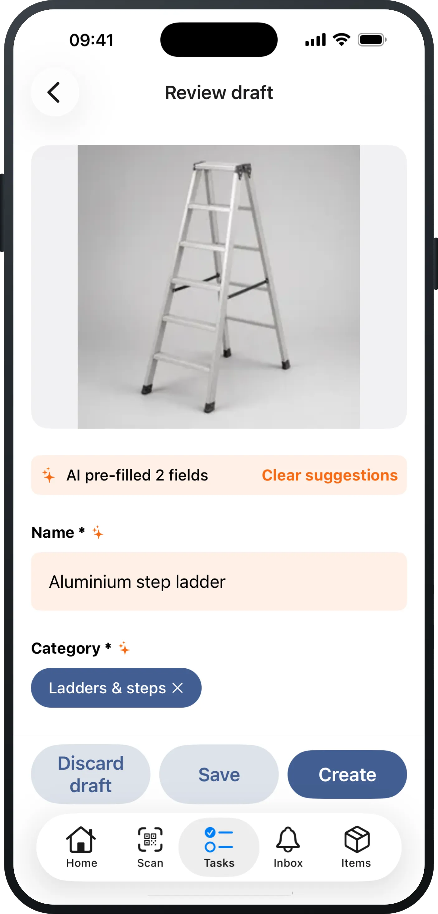 An iPhone showing a freshly photographed capture in Mango Inventory: the photo of an aluminium step ladder at the top, below it the “AI pre-filled 2 fields” note and the already filled-in “Name” (“Aluminium step ladder”) and “Category” (“Ladders & steps”) fields, and the buttons “Discard draft”, “Save” and “Create” at the bottom.